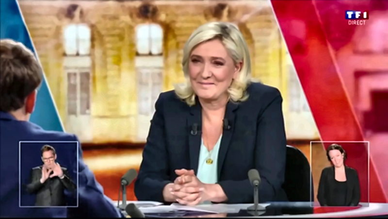 Figure 13. Marine Le Pen : sourire fermé, mains serrées et contre-ironie maîtrisée — 61 min 11 s/61 min 23 s