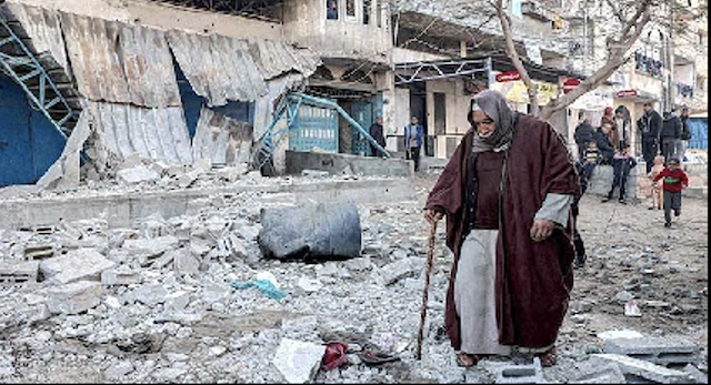 Figure 2. Older man walking among rubble and destroyed buildings